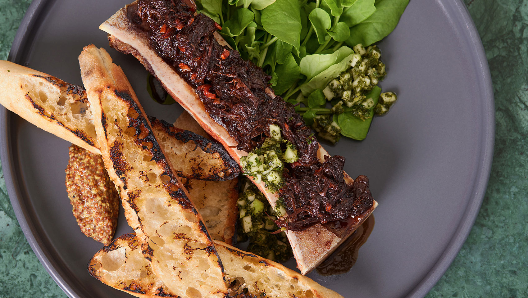 Close up of rib appetizer with grain mustard and toast points