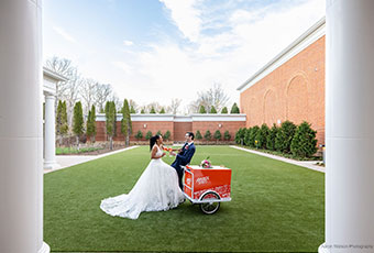 bride and groom with Aperol Spritzes at the Aperol Spritz cart