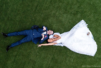 bride and groom laying on the lawn at kimpton forum hotel