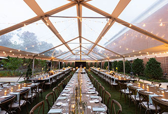 outdoor wedding reception table set up under tent at kimpton forum hotel