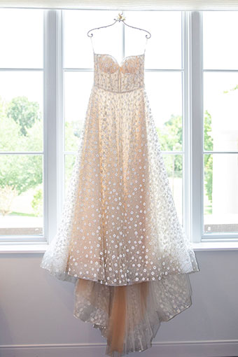 Wedding dress hanging in the window at Kimpton Forum hotel