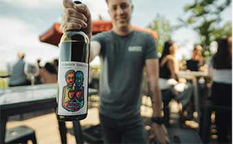 Man with Blenheim wine bottle